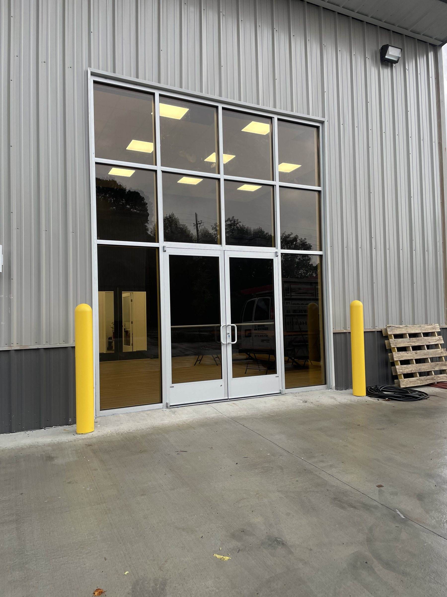 Aluminum storefront with tall glass panels in a steel building